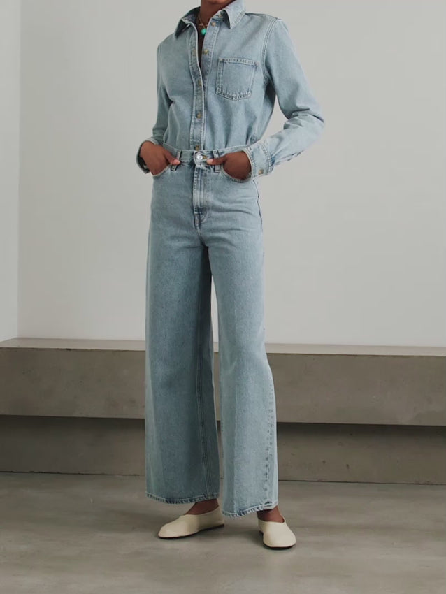 Crafted from organic cotton, these high-rise wide-leg jeans embody effortless sophistication. The elevated waistline creates a flattering silhouette while the generous leg width offers contemporary ease and movement. Designed as a modern wardrobe essential, they pair seamlessly with minimalist basics to create timeless, versatile outfits. A foundational piece that transcends seasonal trends.