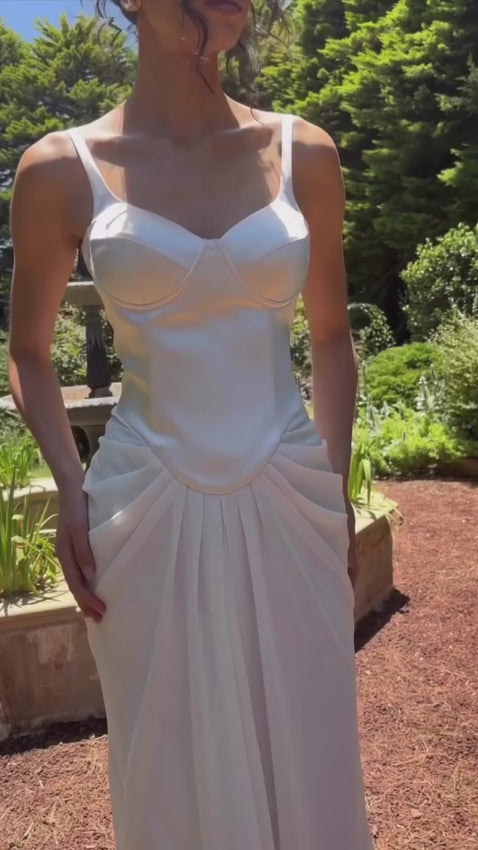 Indulge in luxury with the Remi Maxi Dress. The bustier bodice and corseted waist flatter your figure, while the ruched skirt adds dimension and texture. Slip into this statement piece effortlessly with the centre-back zip. Perfect for those who embrace their curves with confidence in mind.